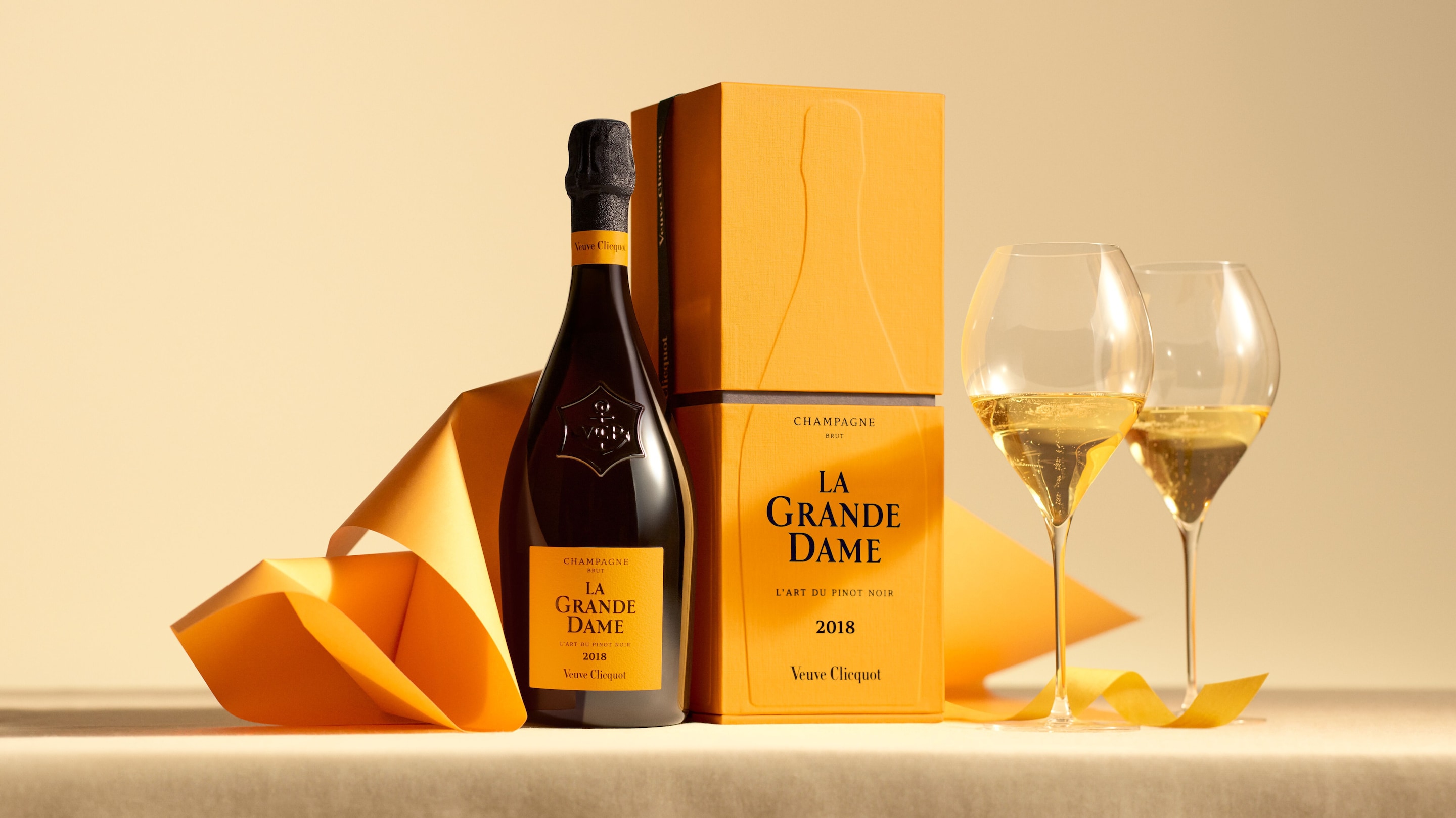 Glasses of Veuve Clicquot champagne on a table and one la grande dame bottle